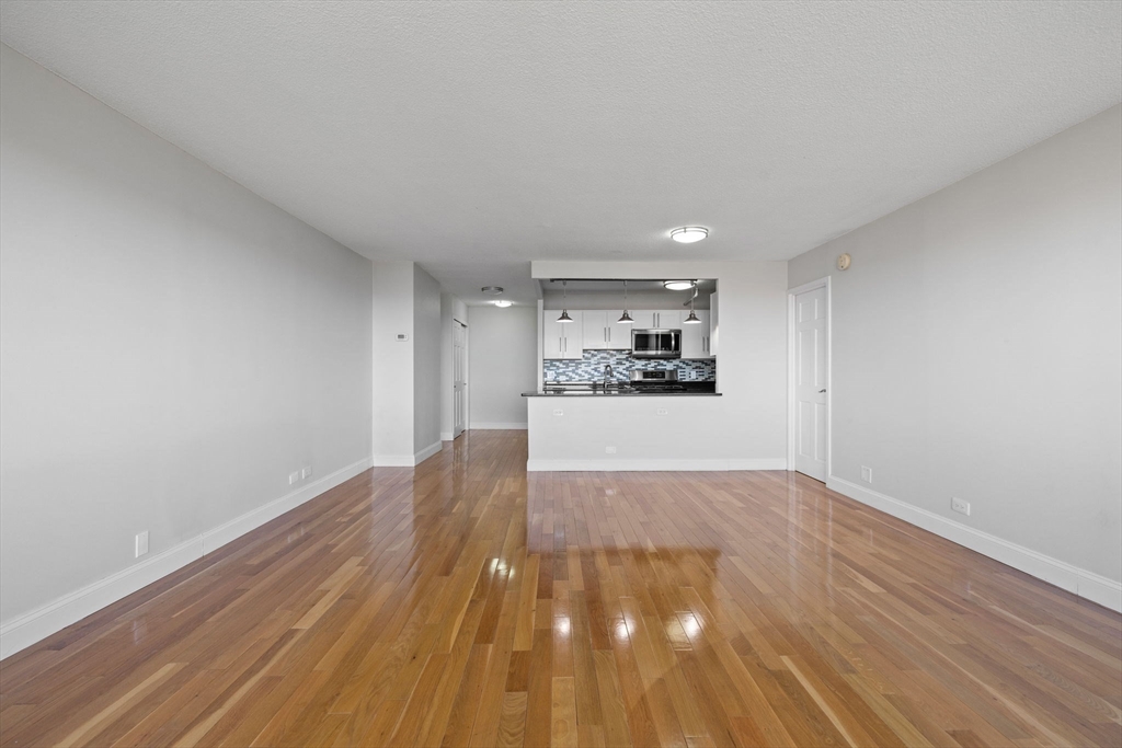 151 Tremont Street, Unit 24P Boston, MA 02111 - Photo 4 of 38 a view of a livingroom with wooden floor