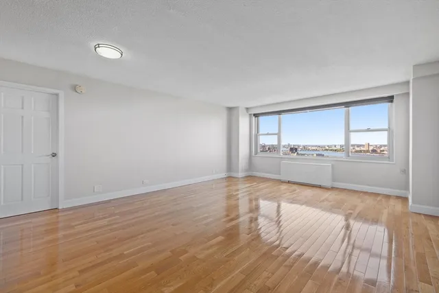 a view of a kitchen with wooden floor and a sink