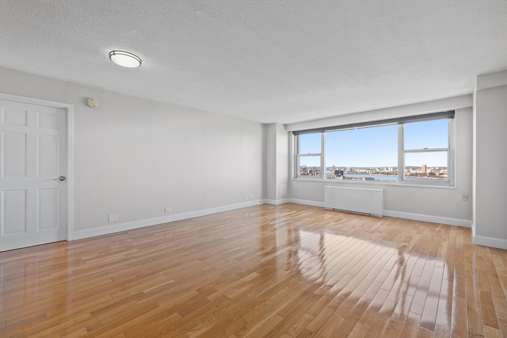 151 Tremont Street, Unit 24P Boston, MA 02111 - Photo 7 of 38 a view of a kitchen with wooden floor and a sink