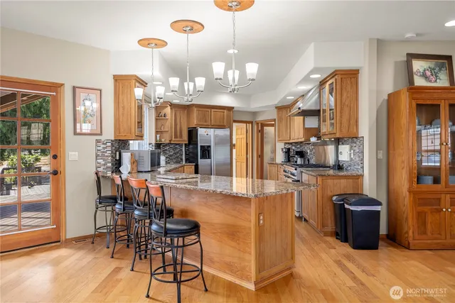 a large kitchen with a table and chairs
