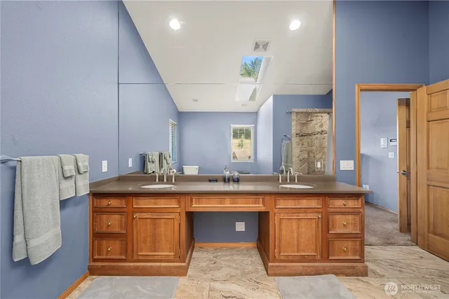 a kitchen with stainless steel appliances granite countertop a sink a stove and a refrigerator