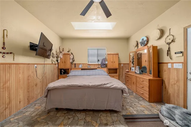 a bed room with a bed and a television