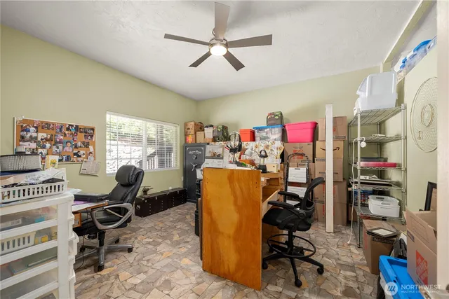 a view of a room with workspace and music instruments