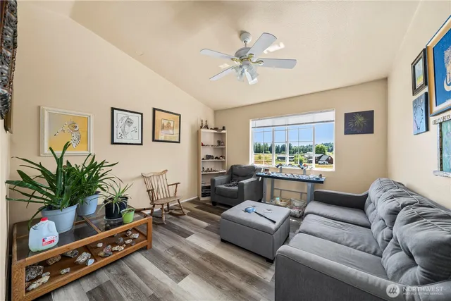 a living room with furniture and a potted plant