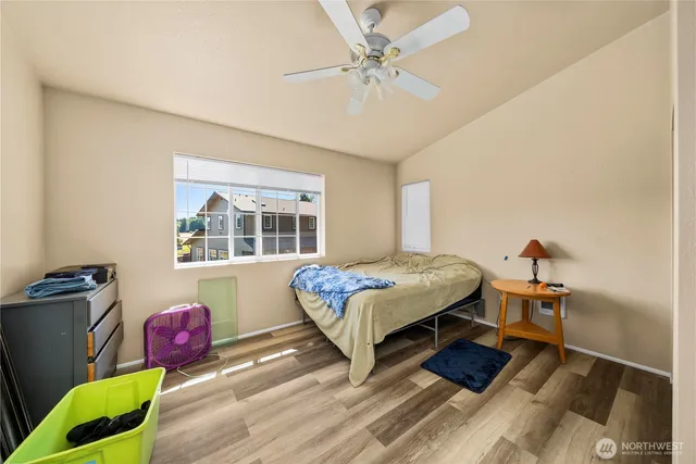 a bedroom with a bed dresser and a window