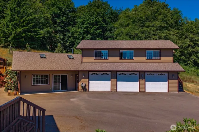 a front view of a house with a garden