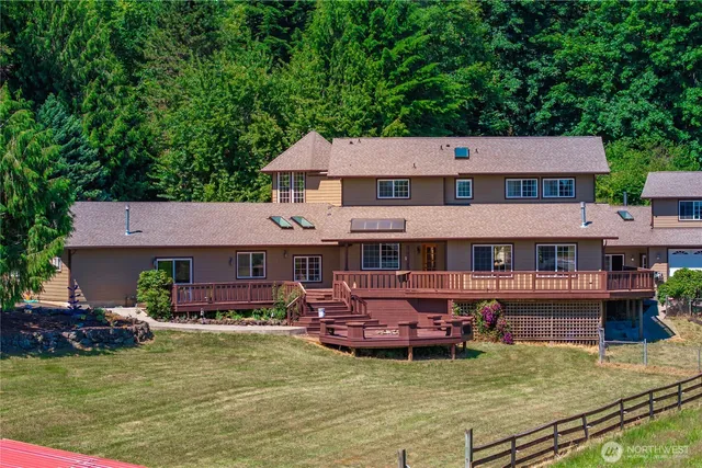 a aerial view of a house with swimming pool having outdoor seating