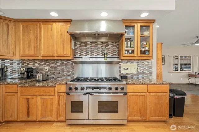 a kitchen with granite countertop a stove and a sink