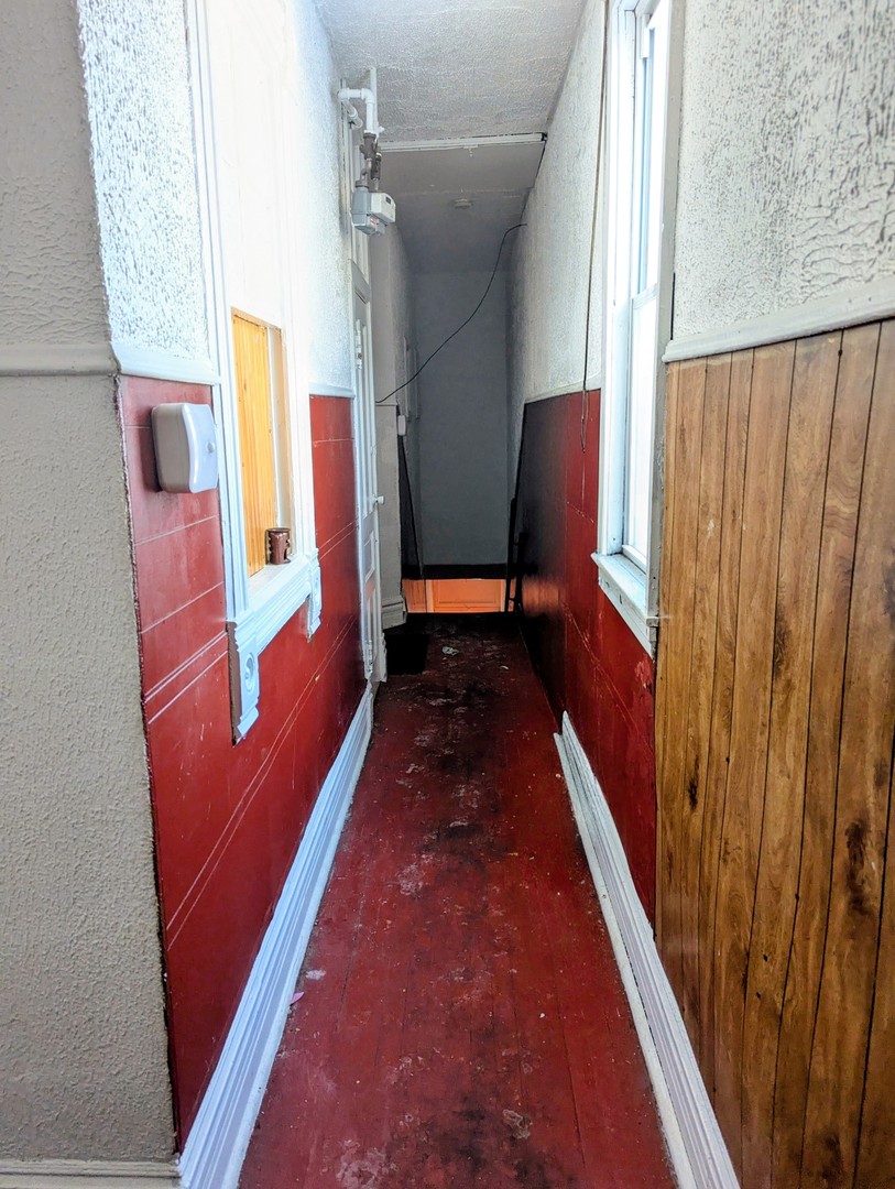 4805 South Elizabeth Street Chicago, IL 60609 - Photo 13 of 18 a hallway with sitting area and wooden floor