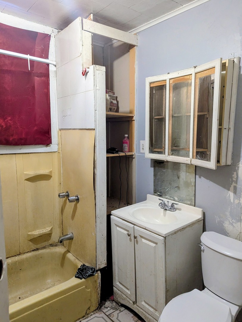 4805 South Elizabeth Street Chicago, IL 60609 - Photo 8 of 18 a bathroom with a sink a toilet and a shower