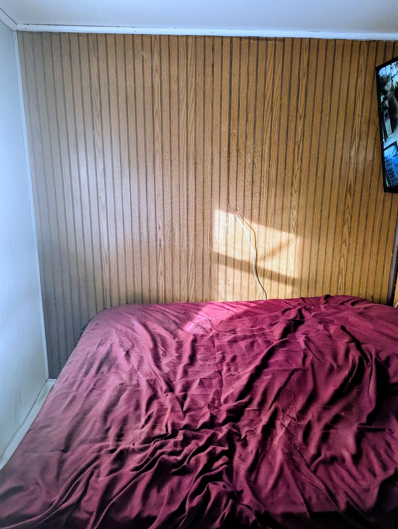 4805 South Elizabeth Street Chicago, IL 60609 - Photo 10 of 18 a bed sitting in a bedroom next to a window