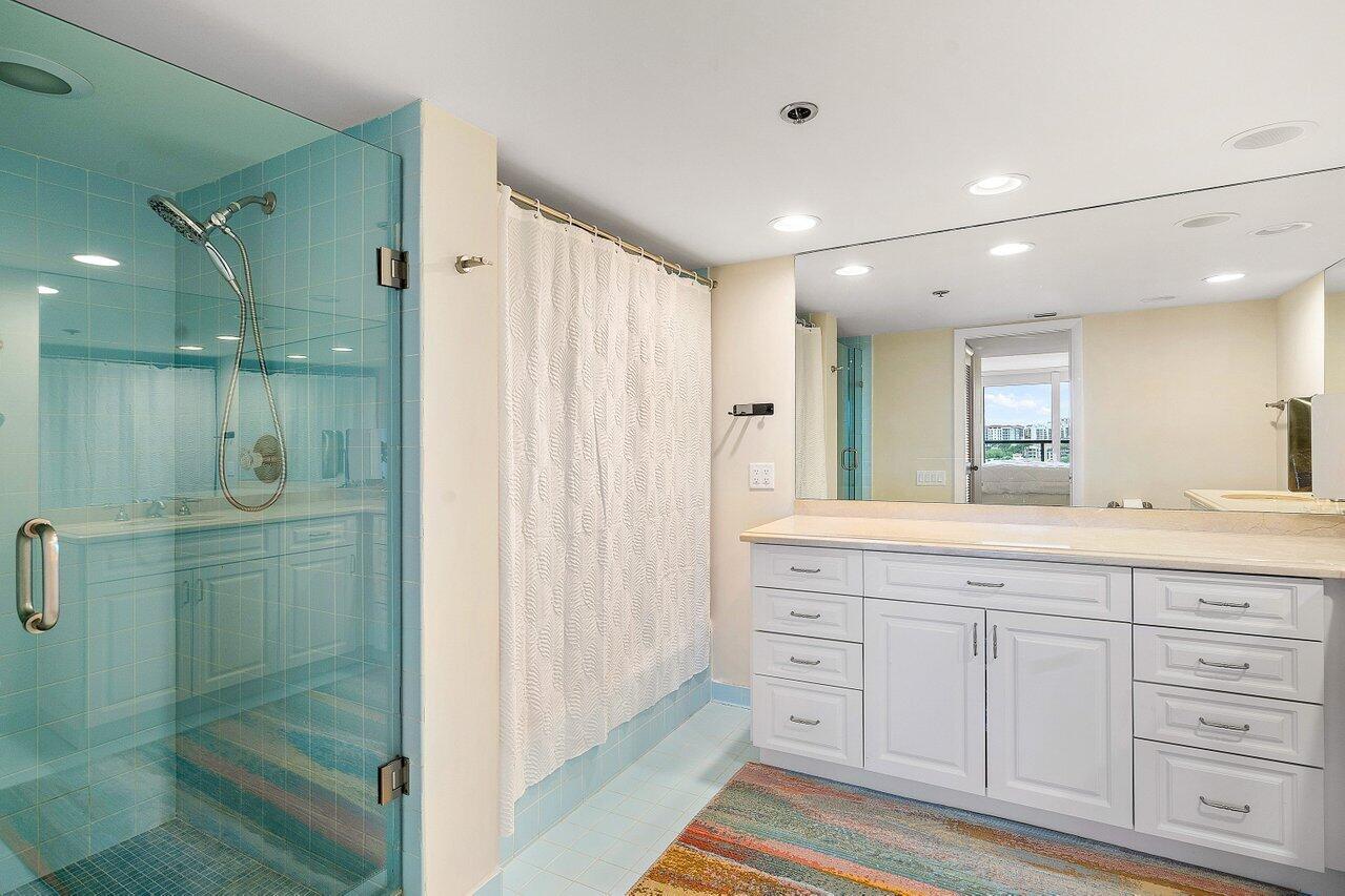 250 South Ocean Boulevard, Unit 10C Boca Raton, FL 33432 - Photo 12 of 33 a bathroom with a granite countertop sink mirror and shower