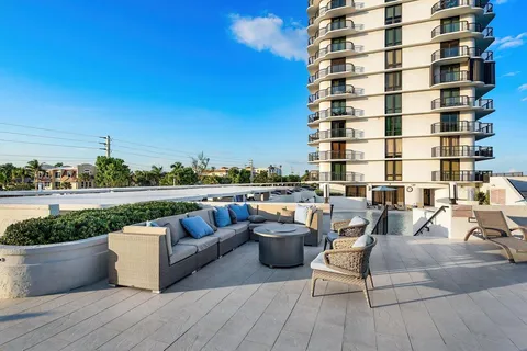 a view of roof deck with seating space and potted plants