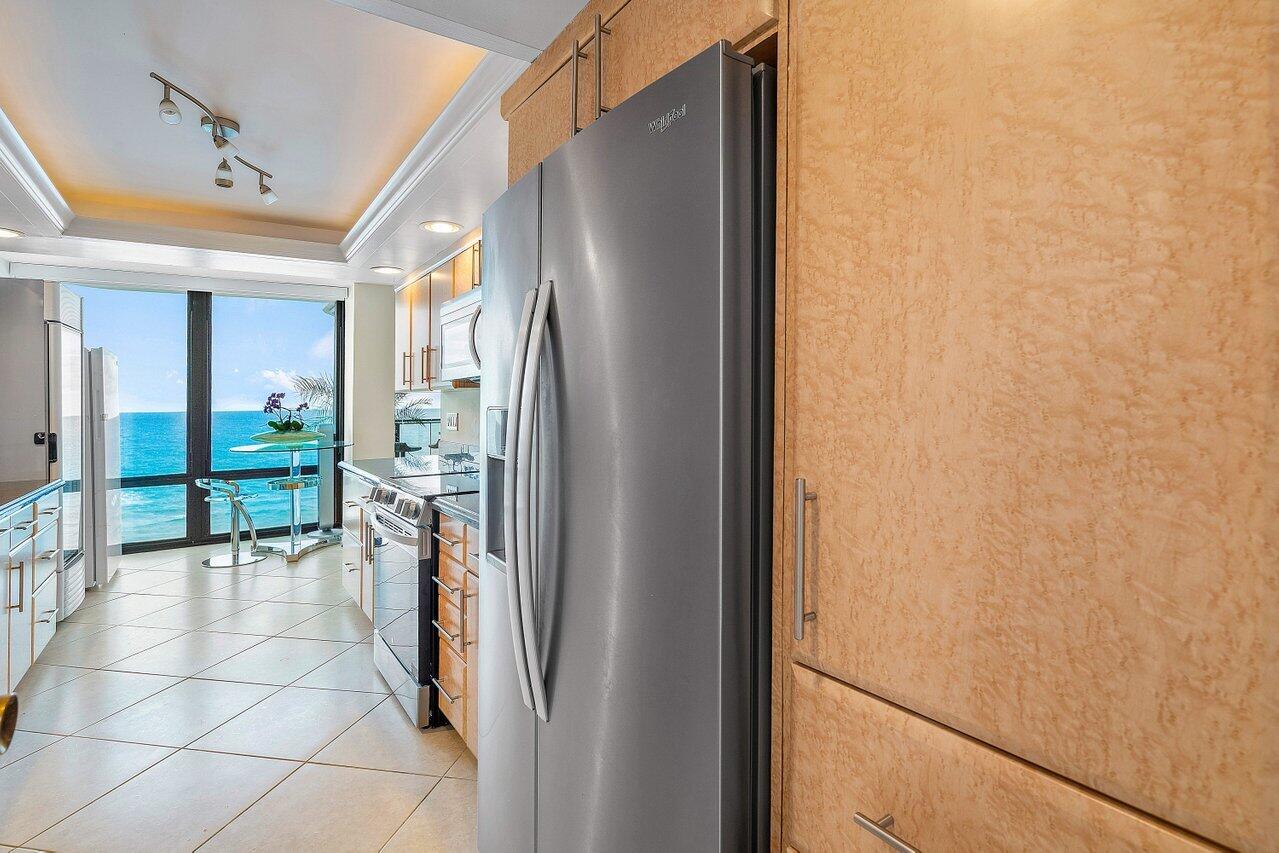 250 South Ocean Boulevard, Unit 10C Boca Raton, FL 33432 - Photo 5 of 33 a view of a hallway with a dining table and chairs
