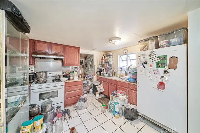a kitchen with stainless steel appliances granite countertop a refrigerator and a stove top oven