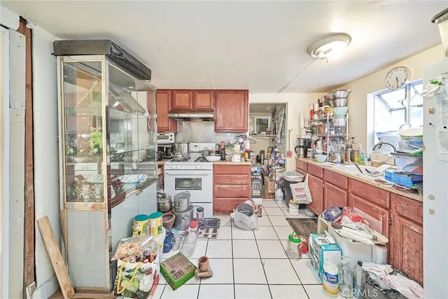 a kitchen with stainless steel appliances kitchen island granite countertop a refrigerator and a stove