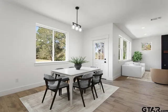 a view of a dining room with furniture window and wooden floor