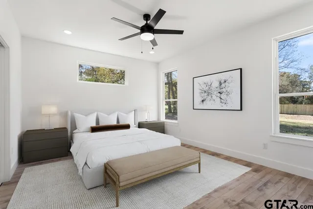 a bedroom with a bed and a painting on the wall