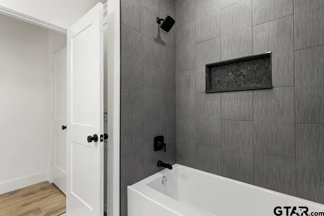 a bathroom with a bathtub and shower