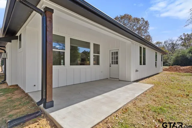 a swimming pool with trees in front of it