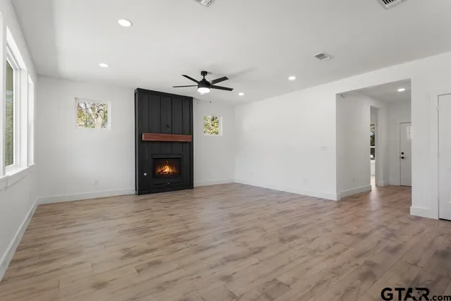 a view of an empty room with a fireplace
