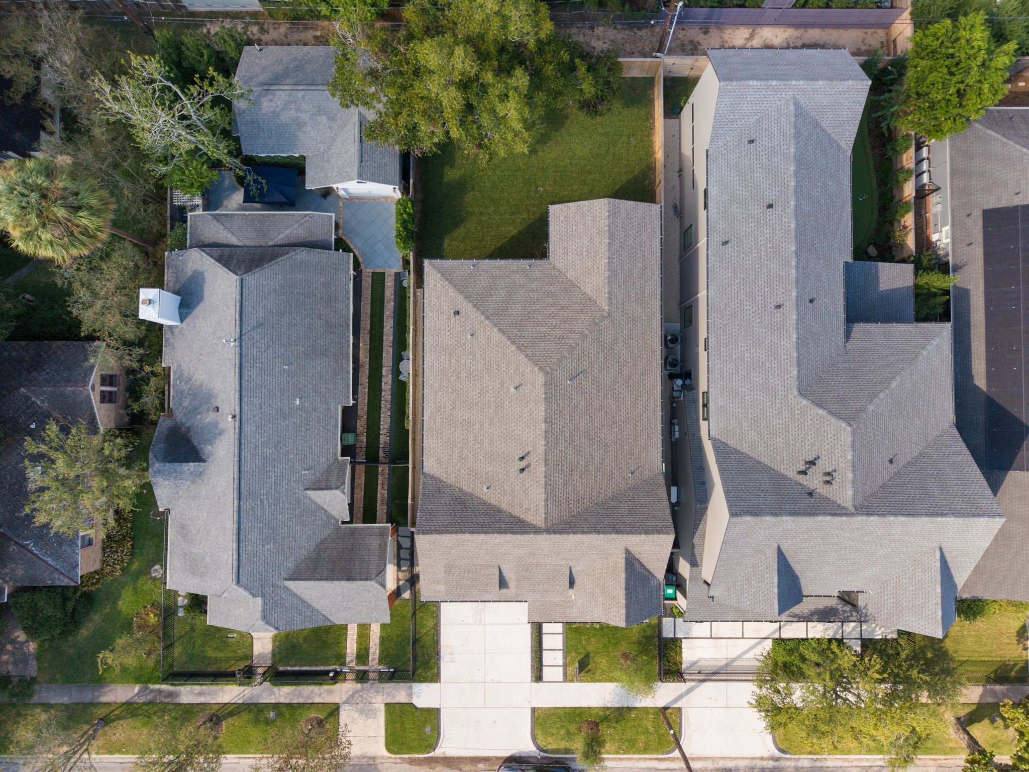 711 East 12th Street Houston, TX 77008 - Photo 45 of 47 This aerial view showcases the home’s generous 6,250-square-foot lot, with a broad backyard and a mature tree tucked into the corner to preserve open lawn. A double-width driveway and attached garage add everyday convenience to this Heights address.