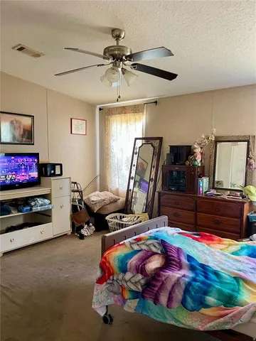 a bedroom with bed and a chandelier