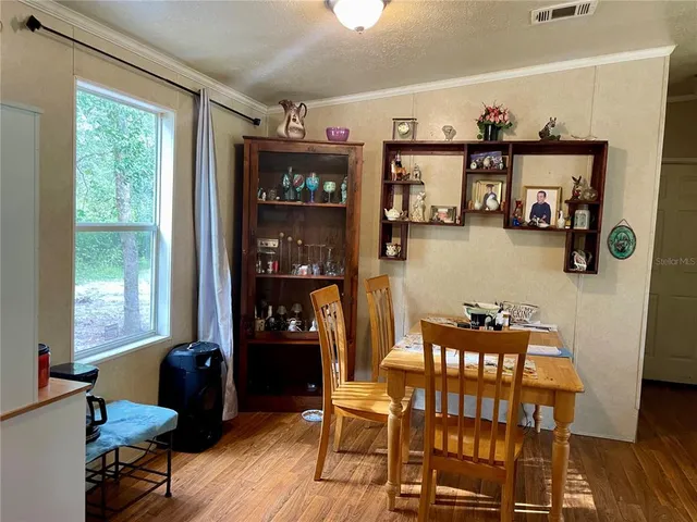 a dining room with furniture and window