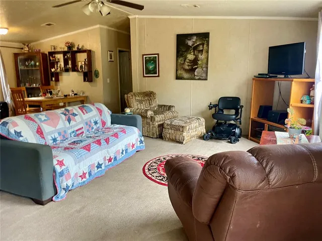 a bedroom with furniture and a flat screen tv
