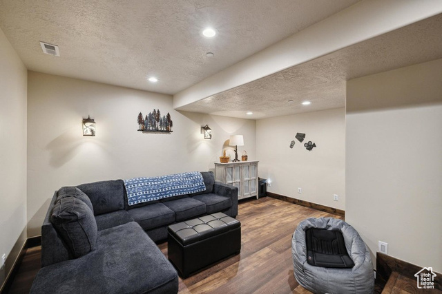 6117 North Rocky Ridge Road Peoa, UT 84061 - Photo 66 of 83 Living room with wood-type flooring and a textured ceiling