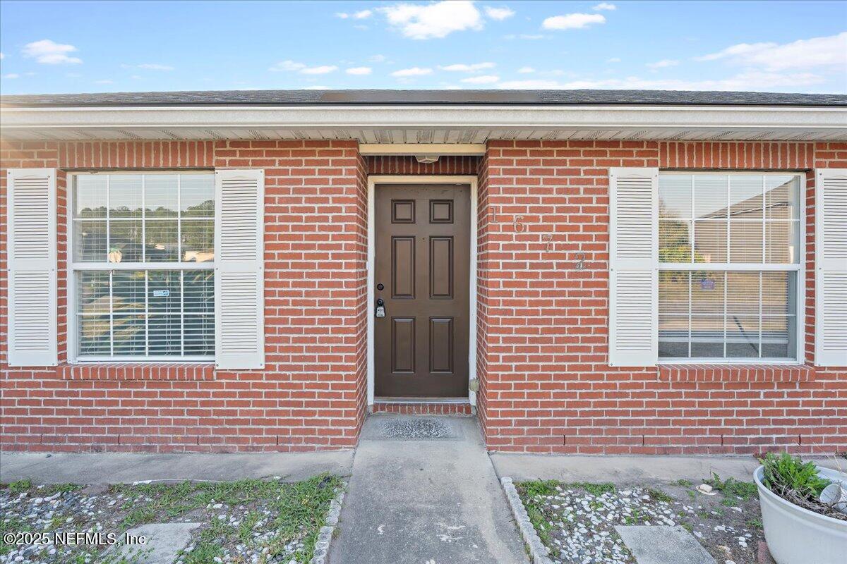 1672 Avenger Lane Jacksonville, FL 32221 - Photo 12 of 48 a view of a brick house with a door and a window