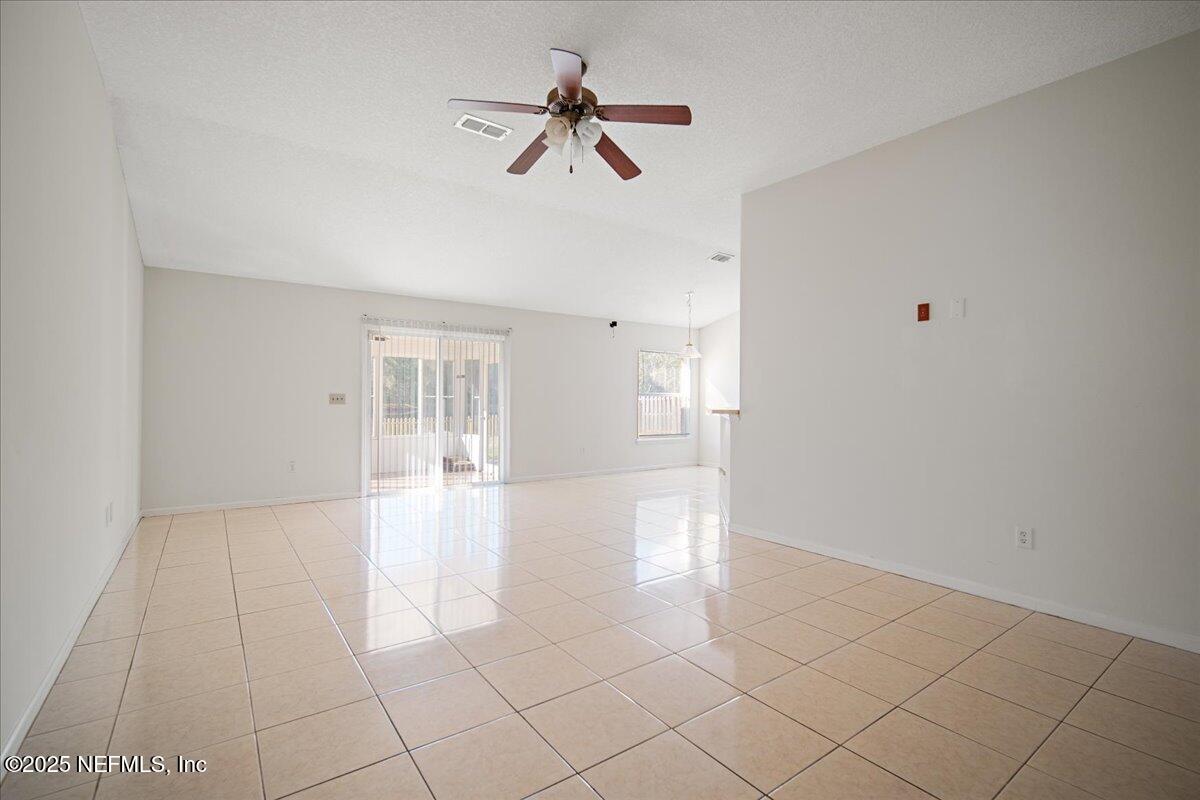 1672 Avenger Lane Jacksonville, FL 32221 - Photo 19 of 48 a view of an empty room with a ceiling fan and window