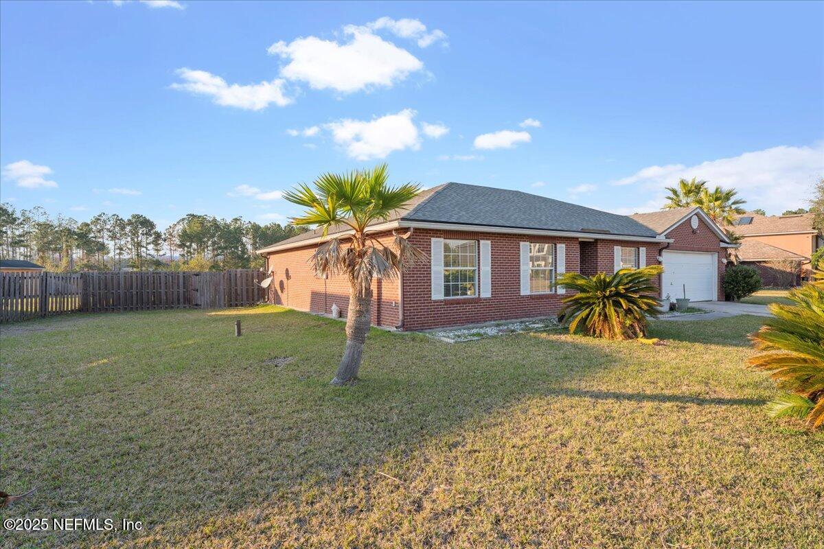 1672 Avenger Lane Jacksonville, FL 32221 - Photo 2 of 48 a view of a house with a backyard and a tree