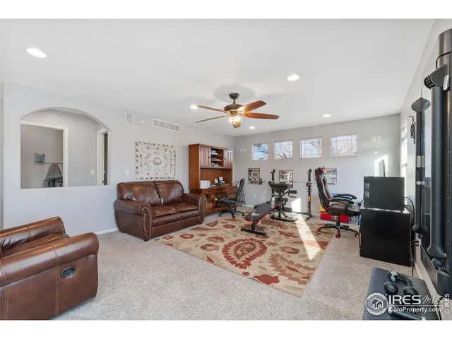 a living room with furniture kitchen view and a flat screen tv