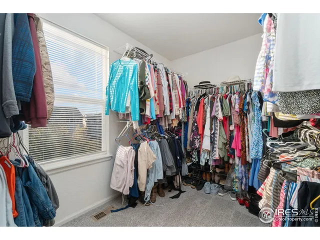 a view of walk in closet with clothes
