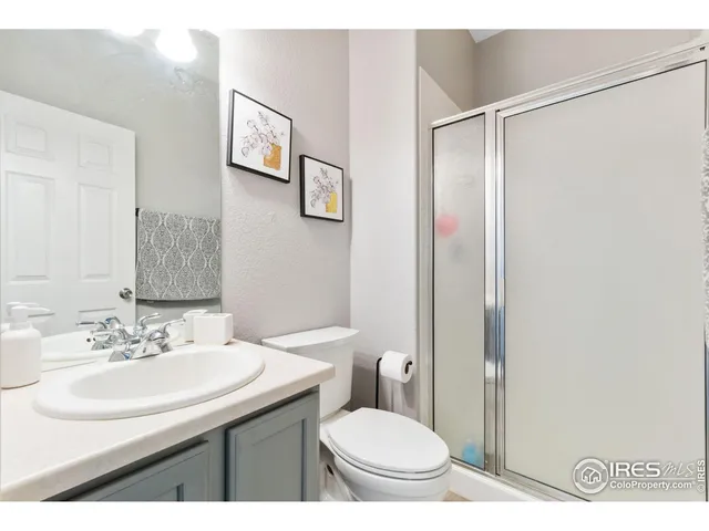 a bathroom with a sink toilet and a mirror