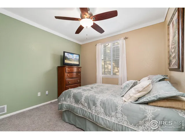 a bedroom with a large bed dresser and a window