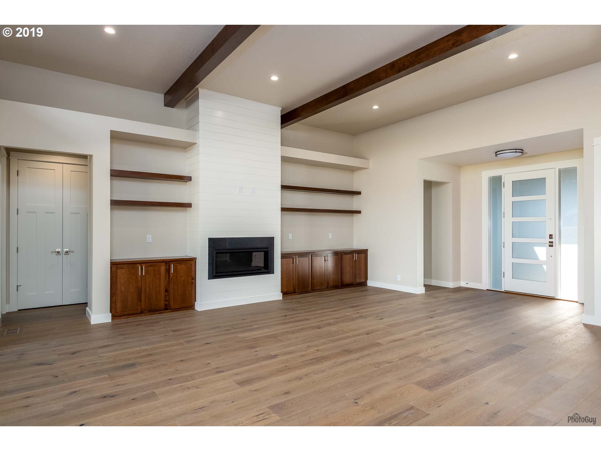 993 South 66th Court Springfield, OR 97478 - Photo 5 of 32 a view of an empty room with wooden floor and closet