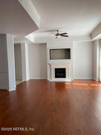 a view of a kitchen with a sink and wooden floor