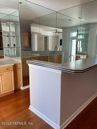 a kitchen with a refrigerator sink and cabinets