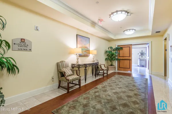 a living room with furniture potted plant and a large window