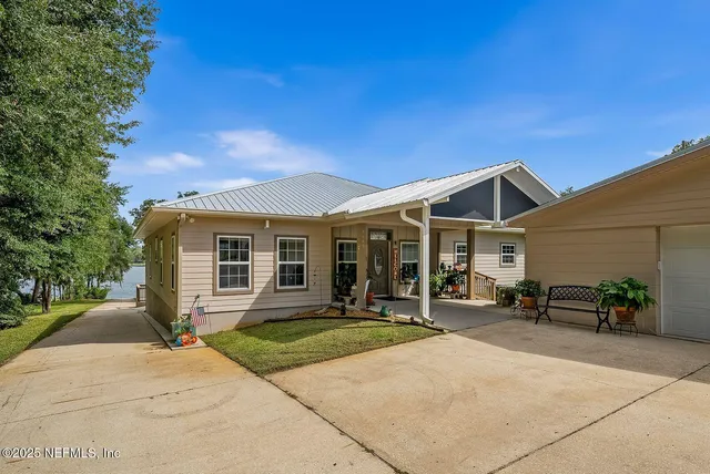 a front view of house with yard outdoor seating and barbeque oven