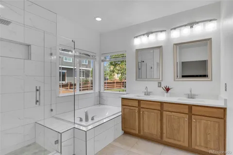 a bathroom with a tub a sink and mirror