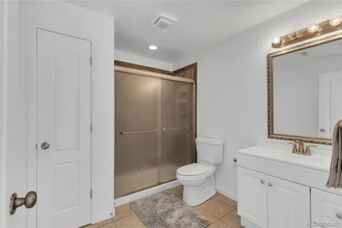 a bathroom with a toilet sink and shower