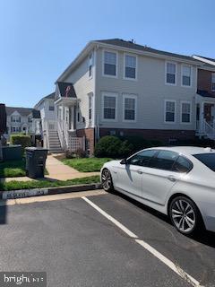 a view of a car parked in front of a brick house