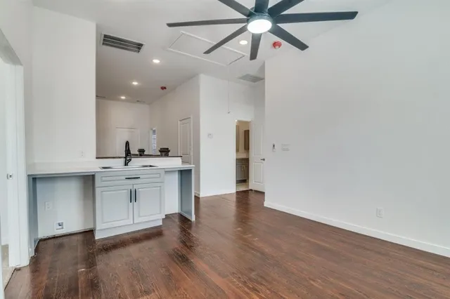 a view of a kitchen with a sink and a refrigerator