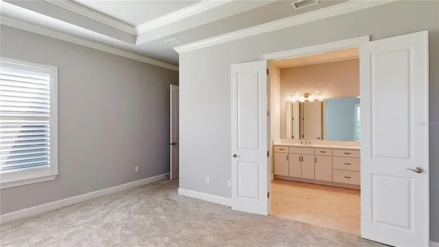 a spacious bathroom with double sink and a mirror