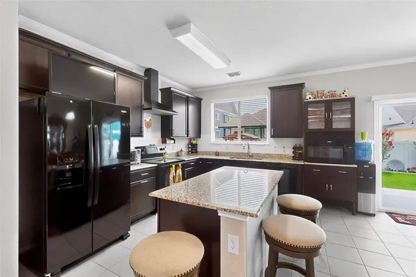 a kitchen with a stove a sink dishwasher and a refrigerator