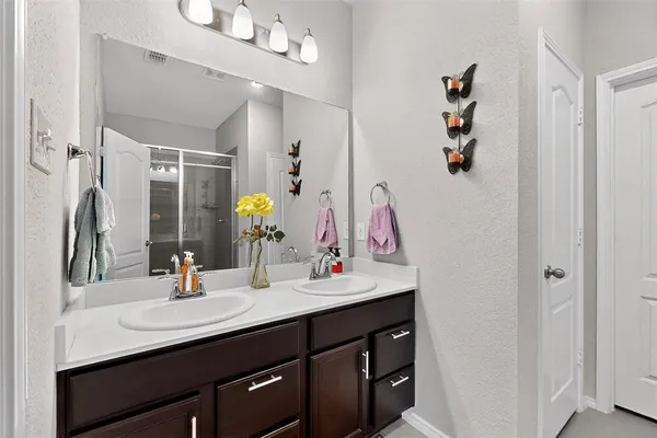 a bathroom with a glass shower door
