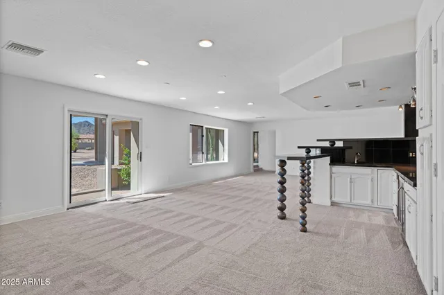 a kitchen with stainless steel appliances a sink a stove a refrigerator and cabinets
